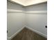 Spacious walk-in closet with carpeted floor, ample storage, and neutral paint at 7575 Sweetwater Dr, Nashville, NC 27856