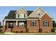 Beautiful brick home featuring a modern design, symmetrical windows and a well-maintained lawn at 7575 Sweetwater Dr, Nashville, NC 27856