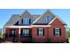 Beautiful new construction home with a brick facade, gray siding, and a well-manicured front yard at 7575 Sweetwater Dr, Nashville, NC 27856