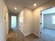 Hallway with neutral carpet, leading to bedrooms, closets and a bathroom; recessed lighting provides great illumination at 7575 Sweetwater Dr, Nashville, NC 27856