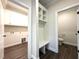 Hallway with storage cabinets, bench and coat hooks leading to a half bath at 7575 Sweetwater Dr, Nashville, NC 27856