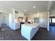 Bright kitchen features white cabinets, large island with sink, and stainless steel appliances at 7575 Sweetwater Dr, Nashville, NC 27856