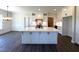 Modern kitchen boasts a large island, white cabinets, and an open layout to the dining room at 7575 Sweetwater Dr, Nashville, NC 27856