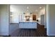 Open-concept kitchen featuring a large center island with white cabinets and dark floors at 7575 Sweetwater Dr, Nashville, NC 27856