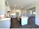 Open kitchen features white cabinets, large island, stainless appliances and hardwood floors at 7575 Sweetwater Dr, Nashville, NC 27856
