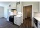 Modern kitchen includes stainless appliances, white cabinets and quartz countertop space at 7575 Sweetwater Dr, Nashville, NC 27856