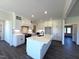 Bright kitchen boasts white cabinets, a large island with sink, and hardwood floors at 7575 Sweetwater Dr, Nashville, NC 27856