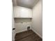 Clean laundry room featuring white cabinets, washer/dryer hookups, and wood-look flooring at 7575 Sweetwater Dr, Nashville, NC 27856