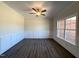 Stylish living room featuring hardwood floors, wainscoting, and a ceiling fan at 7575 Sweetwater Dr, Nashville, NC 27856