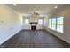 Bright, spacious living room with fireplace, built-in cabinets, ceiling fan, and dark floors at 7575 Sweetwater Dr, Nashville, NC 27856