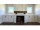 Living room featuring fireplace with white cabinets and shelves on either side and dark floors at 7575 Sweetwater Dr, Nashville, NC 27856