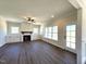 Bright living room featuring a fireplace, built in cabinets, and a side door to the yard at 7575 Sweetwater Dr, Nashville, NC 27856