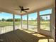 Covered porch with wood decking overlooking open backyard and natural light at 7575 Sweetwater Dr, Nashville, NC 27856