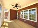 Covered brick porch with natural light and backyard view at 7575 Sweetwater Dr, Nashville, NC 27856