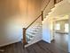 Bright foyer featuring a staircase with wood railing, leading to the upper level at 7575 Sweetwater Dr, Nashville, NC 27856