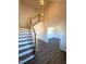 Welcoming foyer featuring a staircase with wood trim and chandelier above dark floors at 7575 Sweetwater Dr, Nashville, NC 27856