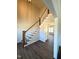 Bright entryway with staircase, wood trim, and dark floors that flows into the home at 7575 Sweetwater Dr, Nashville, NC 27856