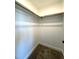 A well-lit walk-in closet with hanging rods provides a simple, functional storage space at 7575 Sweetwater Dr, Nashville, NC 27856
