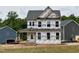Exterior view of a two-story house with a covered front porch, still under construction at 8816 Melvin St # 15, Willow Springs, NC 27592