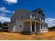 New two-story home with a covered front porch, gray siding, and black accents at 8816 Melvin St # 15, Willow Springs, NC 27592