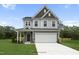 Two-story house with gray siding, white trim, and a two-car garage at 8816 Melvin St # 15, Willow Springs, NC 27592