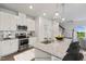Modern kitchen with white cabinets, granite countertops, and island with seating at 8816 Melvin St # 15, Willow Springs, NC 27592