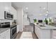 Open concept kitchen with island, stainless steel appliances, and view of living room at 8816 Melvin St # 15, Willow Springs, NC 27592