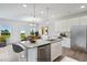 Open concept kitchen with island, stainless steel appliances, and view of dining area at 8816 Melvin St # 15, Willow Springs, NC 27592