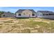 Image of a white home with a backyard that features a patio and green space at 91 Laramie Ln, Selma, NC 27576