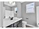 Modern bathroom with a sleek vanity, quartz countertop, contemporary fixtures, and natural light from the window at 91 Laramie Ln, Selma, NC 27576
