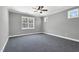 Spacious bedroom with carpet, a ceiling fan, crown molding, and three windows allowing ample natural light at 91 Laramie Ln, Selma, NC 27576