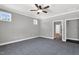 Large bedroom has carpet flooring, ceiling fan, and a view of closet and bathroom at 91 Laramie Ln, Selma, NC 27576