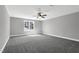 A spacious carpeted bedroom is brightened by a ceiling fan and a large window at 91 Laramie Ln, Selma, NC 27576