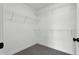 Walk-in closet with wire shelving, carpeted flooring, neutral walls, and a simple design at 91 Laramie Ln, Selma, NC 27576