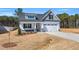 Charming two-story home with a front-facing two car garage and professionally landscaped yard at 91 Laramie Ln, Selma, NC 27576