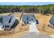 Aerial view of a charming home, expansive yard and driveway in a serene, treed neighborhood at 91 Laramie Ln, Selma, NC 27576