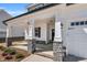 Welcoming front porch with stone-accented columns, stylish lighting, and a sleek black front door at 91 Laramie Ln, Selma, NC 27576