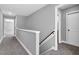 Upstairs hallway with carpet flooring, white trim, and access to multiple rooms at 91 Laramie Ln, Selma, NC 27576