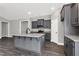 Spacious kitchen with granite countertops and gray cabinets with an island at 91 Laramie Ln, Selma, NC 27576