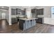 Open kitchen featuring grey cabinets, granite countertops and a kitchen island at 91 Laramie Ln, Selma, NC 27576