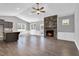 Spacious living room with stone fireplace, hardwood floors, and abundant natural light at 91 Laramie Ln, Selma, NC 27576