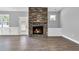 Cozy living room with a stone fireplace, hardwood floors, and natural light at 91 Laramie Ln, Selma, NC 27576