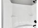 A bright white shower features a shower head and built-in shelving, providing ample space for toiletries at 91 Laramie Ln, Selma, NC 27576