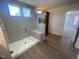 Bright bathroom with a glass enclosed shower, tiled walls, built-in seat, and tiled floor at 113 Arundel Dr, Archer Lodge, NC 27527