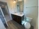 Bright bathroom with double sink vanity, large mirror, and a toilet with a modern design at 113 Arundel Dr, Archer Lodge, NC 27527