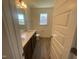 Bathroom features a double vanity, modern fixtures, and plenty of natural light from large windows at 113 Arundel Dr, Archer Lodge, NC 27527
