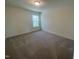 Cozy bedroom featuring neutral carpet, a window overlooking a wooded area, and ample natural light at 113 Arundel Dr, Archer Lodge, NC 27527