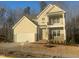 Inviting two-story home with a two-car garage, a balcony, and stone veneer at 113 Arundel Dr, Archer Lodge, NC 27527