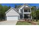 Charming two-story home with a two-car garage, a balcony, and a landscaped yard at 113 Arundel Dr, Archer Lodge, NC 27527