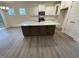 Modern kitchen features a central island, stainless appliances, white cabinets, and sleek countertops at 113 Arundel Dr, Archer Lodge, NC 27527